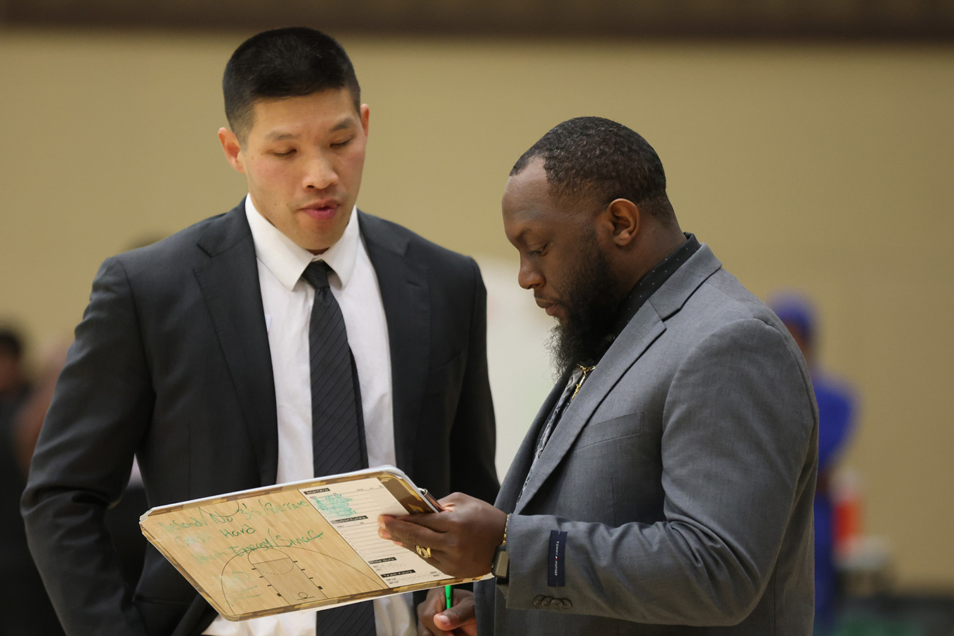 Head Coach Jordan Lee discusses strategy with Assistant Coach Terrence Broussard